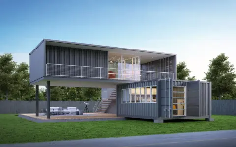 Une maison conteneur moderne à deux étages avec terrasse, escaliers extérieurs et mobilier de jardin.