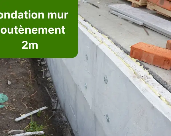 Construction d'un mur de soubassement de 2m, avec des briques rouges et des matériaux isolants.