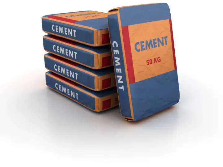 Pile de sacs de ciment de 50 kg, prêts pour le dosage béton dans une bétonnière.