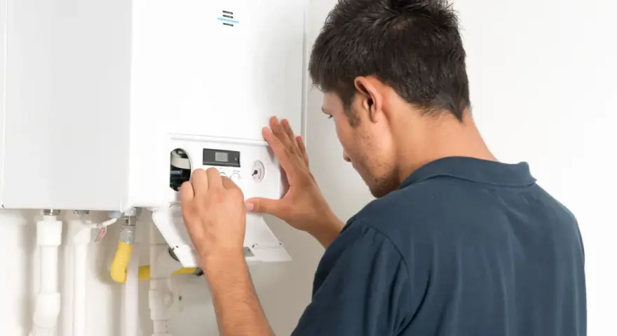 Un technicien ajuste une chaudière à condensation. L'installation est en cours, assurant un chauffage efficace.